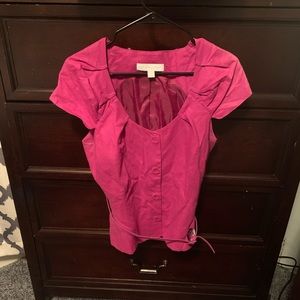 Never work pink sleeveless blouse with belt